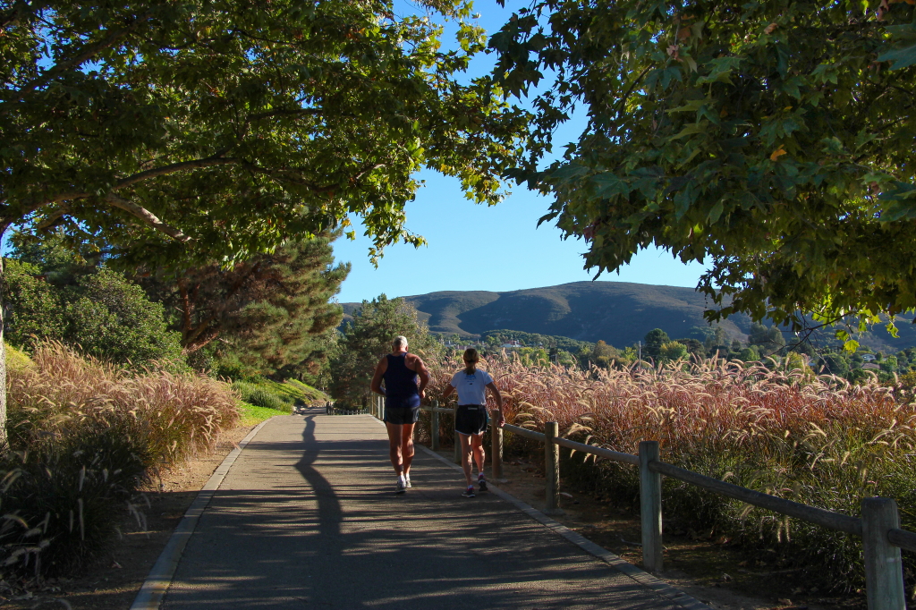 Two people walking along San Marcos trail